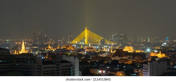 Aerial view of Rama 8 Bridge and Chao Phraya River in structure of suspension architecture concept, Urban city, Bangkok skyline. Downtown area at night, Thailand.