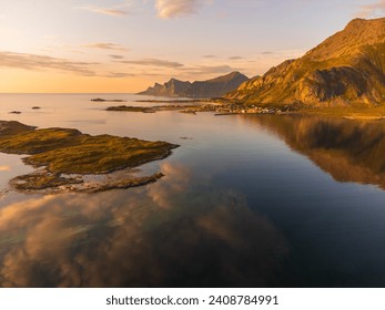 Aerial view of the Ramberg town inlet in Lofoten, Norway with a beautiful sunset light over the fjord sea. Calm waters, reflections. - Powered by Shutterstock