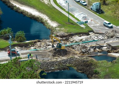 Aerial view of reconstruction of damaged road bridge destroyed by river after flood water washed away asphalt. Rebuilding of ruined transportation infrastructure - Shutterstock ID 2211945719
