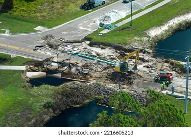 Aerial view of reconstruction of damaged road bridge destroyed by river after flood water washed away asphalt. Rebuilding of ruined transportation infrastructure - Shutterstock ID 2216605213