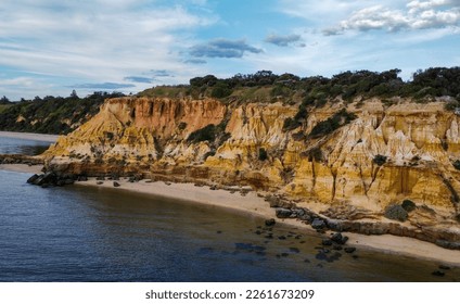 aerial view of red bluff cliff and beach - Shutterstock ID 2261673209