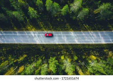 Aerial View Of Red Car On A Country Road In Green Forest In Finland