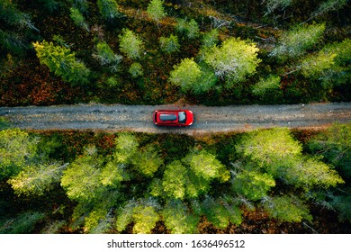 Aerial View Of Red Car For Traveling With A Roof Rack On A Country Road In Finland