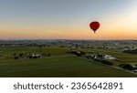 An Aerial View of a Red Hot Air Balloon, Floating Across Rural Pennsylvania, on a Sunny Morning, in the Summer
