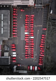 Aerial View Of Red Vans Parked In A Car Park