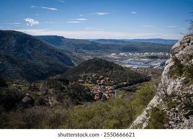 Aerial view of the red-roofed town of Sant'Antonio in Bosco (Boršt), near Trieste, Italy, captured from Via Ferrata Rose d'Inverno, showcasing lush greenery, scenic landscapes, and rural charm. - Powered by Shutterstock