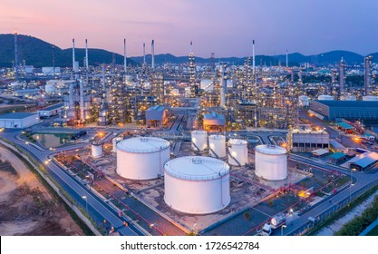 Aerial View Refinery And Oil Storage Tanks At Dusk And Night. Petrochemical And Energy Oil Industries.
