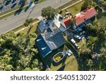 Aerial view of regular american home roof with blue solar photovoltaic panels for producing clean ecological electric energy. Renewable electricity with zero emission concept