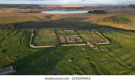 An aerial view of the remains of an auxiliary fort on Hadrian's Wall,  Housesteads Roman Fort, in Northumberland, England,in a middle of a green field - Shutterstock ID 2334290453