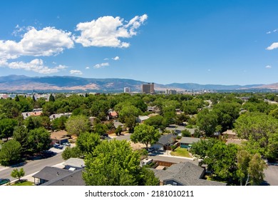 Aerial view of the Reno Sparks Nevada downtown skyline district during summer with mature green trees and a bright blue sky with a few clouds.