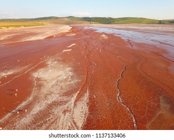 Aerial View Of A Reservoir Full Of Red Toxic Sludge