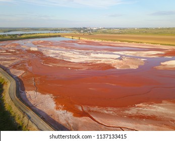 Aerial View Of A Reservoir Full Of Red Toxic Sludge