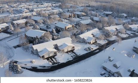 Aerial View Of Residential Houses Covered Snow At Winter Season. Establishing Shot Of American Neighborhood, Suburb.  Real Estate, Drone Shots, Sunny Morning, Sunlight, From Above. 