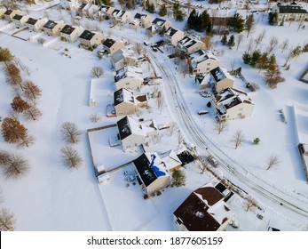 Aerial view of residential houses covered snow with snow on covered houses and roads at winter season - Powered by Shutterstock