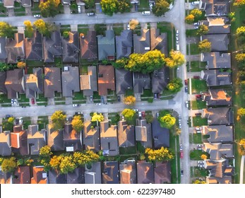 Aerial View Of Residential Houses And Driveways Neighborhood During A Fall Sunset. Tightly Packed Homes, Surrounds With Green Tree Flyover In Houston, Texas, US. Suburban Housing Community Development