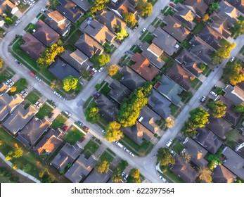 Aerial View Of Residential Houses And Driveways Neighborhood During A Fall Sunset. Tightly Packed Homes, Surrounds With Green Tree Flyover In Houston, Texas, US. Suburban Housing Community Development