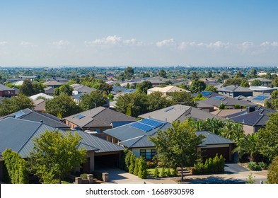 Aerial view of residential houses in Melbourne's suburb. Elevated view of Australian homes against blue sky. Copy space for text. Point Cook, VIC Australia. - Shutterstock ID 1668930598