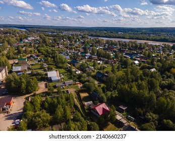 aerial view residential houses near summer river and huge metal bridge
