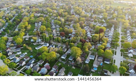 Aerial view of residential houses at spring (may). American neighborhood, suburb.  Real estate, drone shots, sunset, sunlight, from above.
