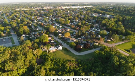 Aerial view of residential houses at summer. American neighborhood, suburb.  Real estate, drone shots, sunset, sunlight, from above.