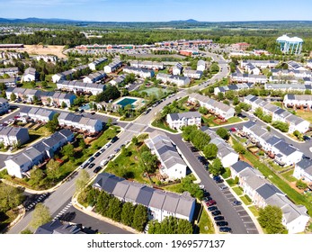Aerial view of residential houses at summer. American neighborhood, suburb. Real estate, drone shots, sunset, sunlight, from above.