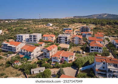 Aerial view of residential neighborhood with red roofed houses at summer day. Small coastal town with colorful buildings in Croatia - Powered by Shutterstock