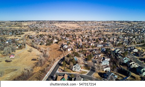 Aerial View Of Residential Neighborhood In Suburbia In Snowless Winter.