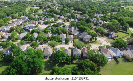 Aerial View Residential Neighborhood Surrounded By Matured Trees And Grassland In Flower Mound, Texas, US. Upscale Parkside Dallas Suburbs Single Family Homes With Large Backyard Lush Green