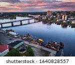 Aerial view of retro steamships at the pier on the Pielisjoki river in Joensuu, Finland. On the sky amazing bright sunset.