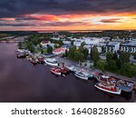 Aerial view of retro steamships at the pier on the Pielisjoki river in Joensuu, Finland. On the sky amazing bright sunset.