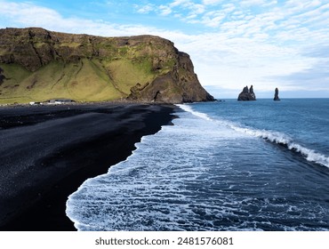 Aerial view of Reynisfjara black sand beach and sea stacks in Iceland. - Powered by Shutterstock