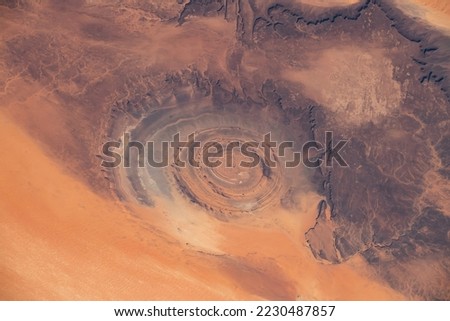 Aerial view of Richat Structure in Mauritania. Also called Guelb er Richât in Arabic Qalb ar-Rīšāt.  Digitally enhanced. Elements of this image furnished by NASA.