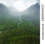 Aerial view of the River Etive as it passes through Glen Etive and Glencoe in the Scottish highlands during rain and fog