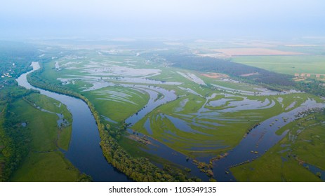 Aerial view of river flood. Beautiful flooded meadow.
Flying above beautiful Desna river when the river is full of water at spring at National Nature Park in Chernihiv Oblast, Ukraine.