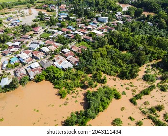 Aerial view river flood village countryside Asia and forest tree, Top view river with water flood from above, Raging river running down jungles lake flowing wild water after the rain