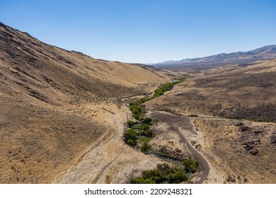 Aerial view of a river running through a canyon in the rugged Arid Nevada desert.