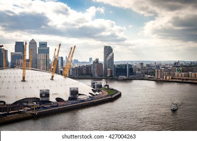 Aerial view of River Thames, North Greenwich and the Docklands on a cloudy day in London, England, UK