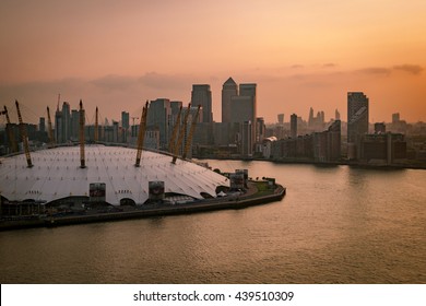 Aerial view of River Thames, North Greenwich and the Docklands on a cloudy day at sunset in London, England, UK