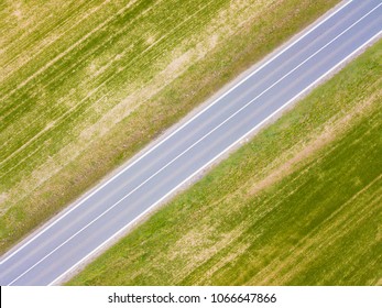 Aerial view of road between fields. Highway from drone view. Background concept.