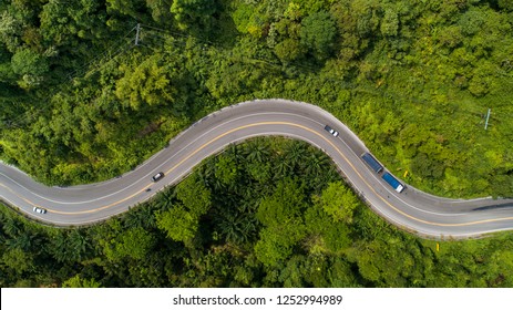 Aerial View Road Curve Construction Up To Mountain 