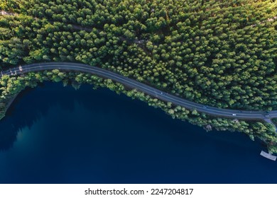 Aerial view of road with green woods by blue lakes water in summer Finland. - Shutterstock ID 2247204817