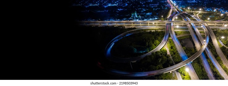 Aerial view of road interchange or highway intersection of Expressway top view, Road traffic an important infrastructure, car traffic transportation above intersection road in city night.