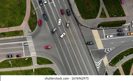 aerial view of road junction or road intersection in city with cars turning left and righ