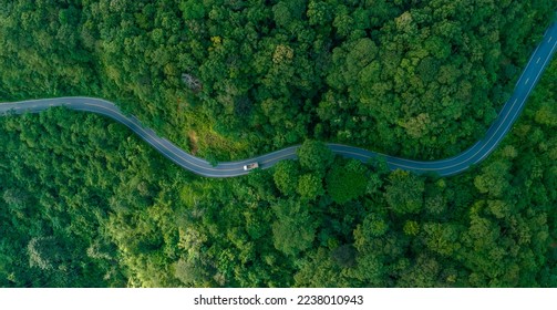 Aerial view of a road in the middle of the forest , road curve construction up to mountain	 - Shutterstock ID 2238010943
