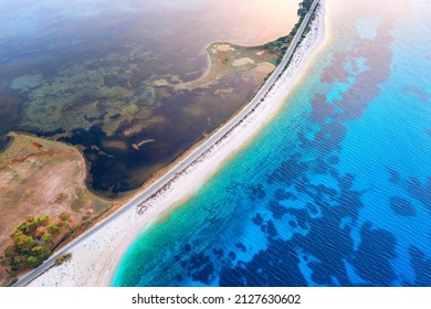 Aerial View Of Road Near Blue Sea And River At Sunset In Summer. Lefkada, Greece. Top View Of Road Between Islands, White Sandy Beach, Sea Coast, Clear Water. Beautiful Landscape. Top View From Drone