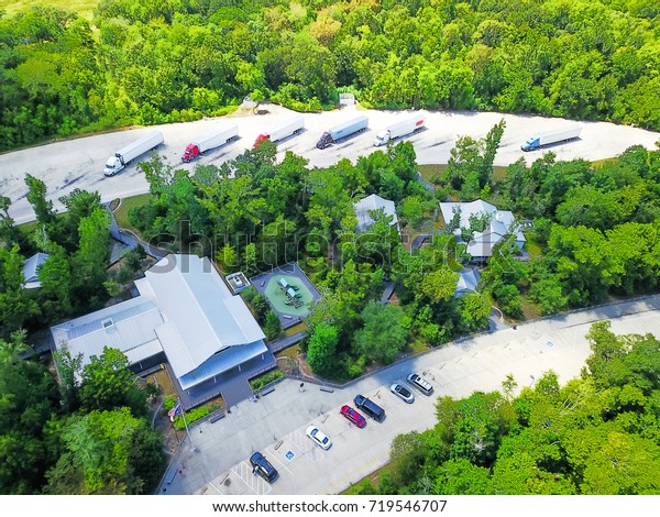 Aerial view of roadside rest area features large\
parking for cars & trucks, shelter building, restroom,\
playground, boardwalks and nature trails. Picnic area along highway\
I-10, Hankamer, Texas,\
USA
