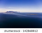 Aerial view of Robben Island with Table Mountain in the distance, Cape Town; South Africa. Former South African President, Nelson Mandela, was held here as a political prisoner for 27 years.