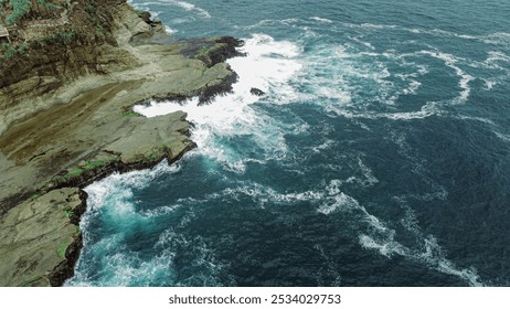 Aerial View of Rocky Coastal Cliffs and Ocean Waves - Powered by Shutterstock