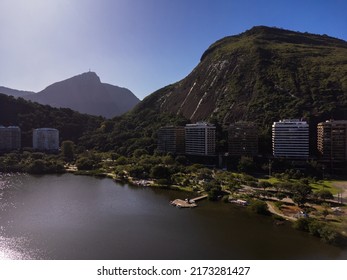 Aerial View Of Rodrigo De Freitas Lagoon, South Zone Of Rio De Janeiro, Brazil. In The Background, The Beaches Of Ipanema And Leblon. Sunny Day. Cars Traveling On Avenida Epitácio Pessoa. Drone Photo.