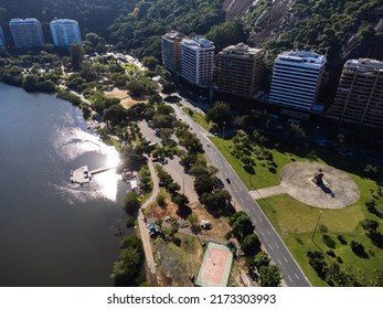 Aerial View Of Rodrigo De Freitas Lagoon, South Zone Of Rio De Janeiro, Brazil. In The Background, The Beaches Of Ipanema And Leblon. Sunny Day. Cars Traveling On Avenida Epitácio Pessoa. Drone Photo.